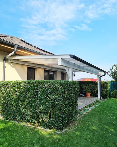 Pergola pri modrej oblohe s dreveným zábradlím terasy